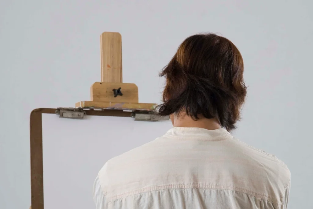 How to Use AI Tools as an Artist (the smart way) Artist infront of an empty easel